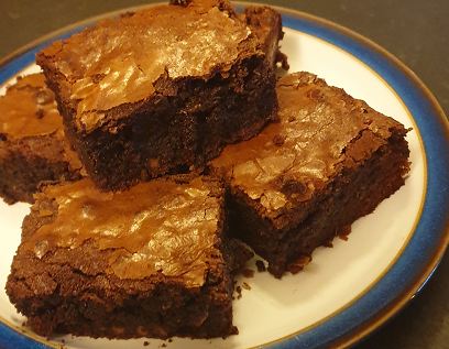 Chocolate brownies stacked on a plate