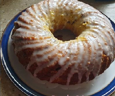 A ring-shaped lemon drizzle cake finished with white drizzle icing