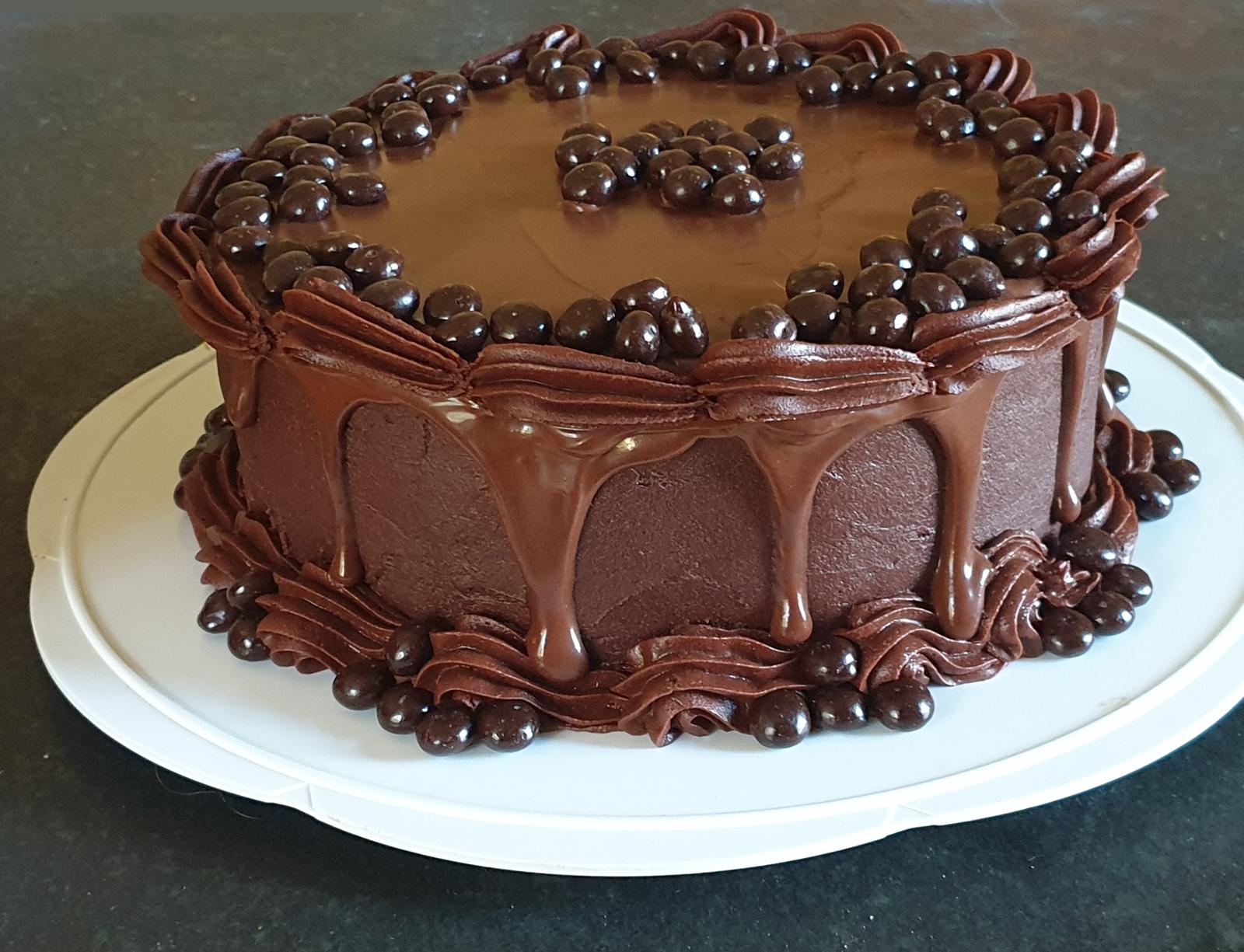 A chocolate fudge cake ringed with chocolate balls and finished with a caramel drip