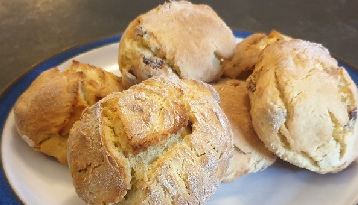 Cheese scones, split and risen, on a blue-rimmed plate