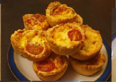 Mini quiches topped with cherry tomato