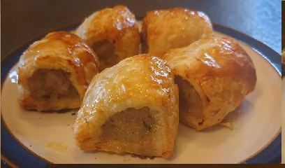 Home-made sausage rolls with a glazed pastry crust